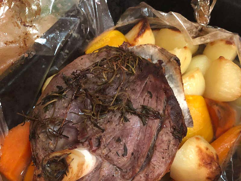 Roast lamb with rosemary and thyme in an oven bag