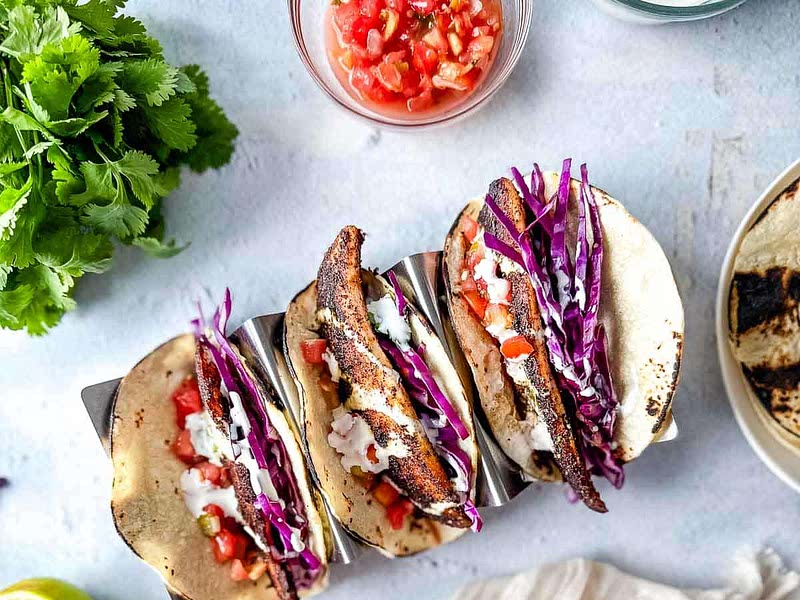 Blackened Redfish Tacos With Cilantro Lime Crema Recipe Whisk blackened-fish-tacos-recipe-kitchen-swagger